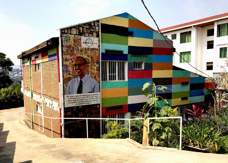 multi-colored building featuring yellows, tans, reds, oranges, and greens_living in kigali