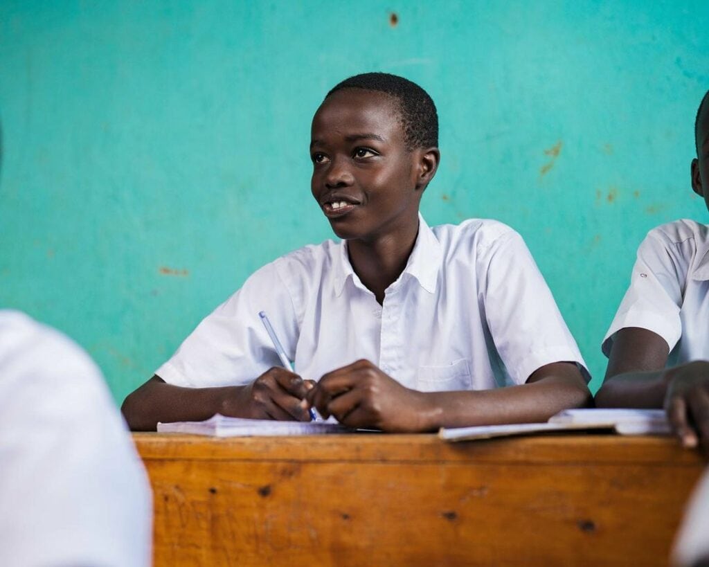 A_boy_in_a_school_setting_learning_Living in Kigali_